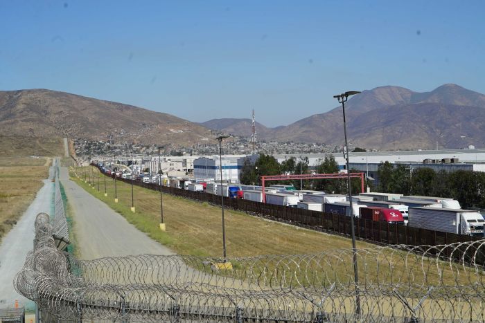 US-Mexico border The US-Mexico border marked by a high, razor-wire fence.
